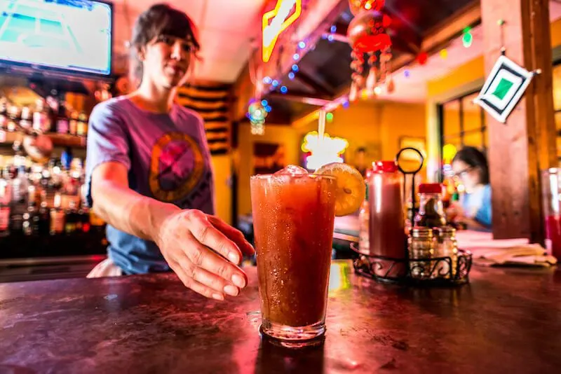 bartender serving a bloody mary