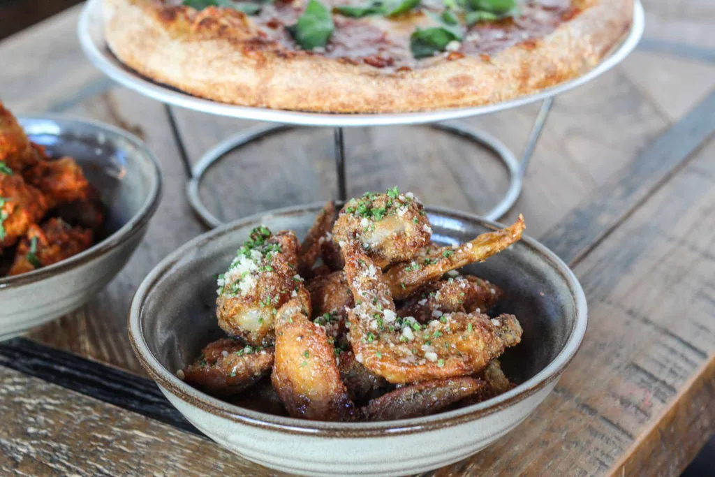 7 Must-Try D.C. Navy Yard Restaurants: Calabrian Chicken Wings, Pizza
