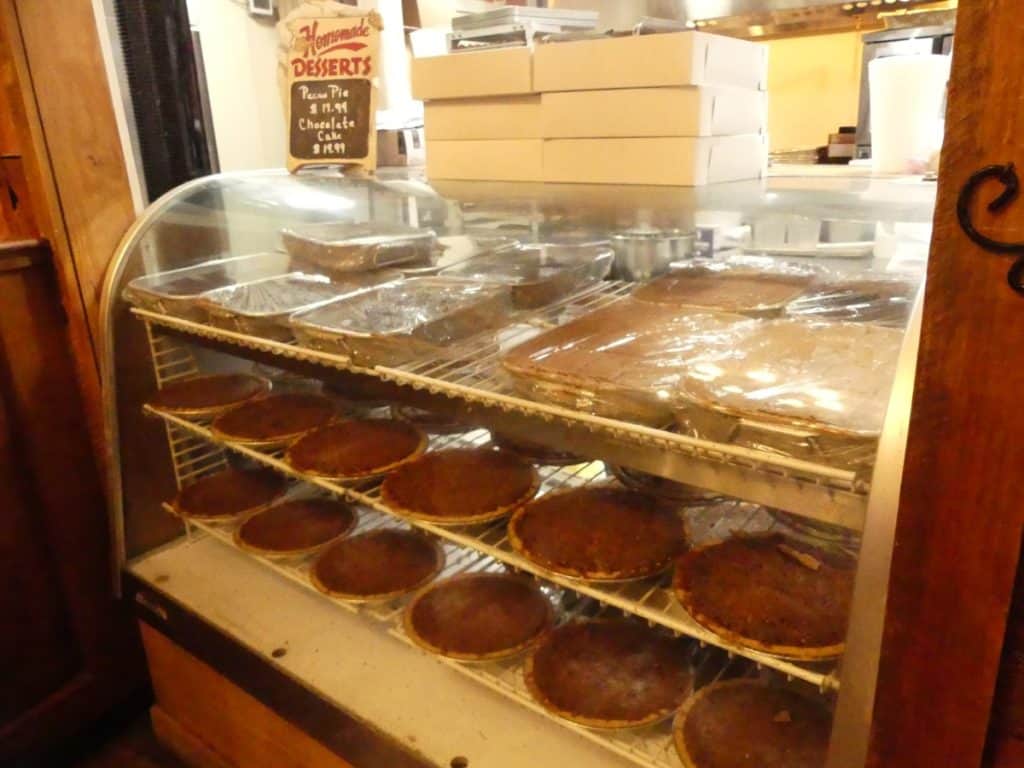 Assorted freshly baked pies displayed in a bakery case.